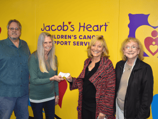 Mussers, Angie and Lori Butterworth give and receive donation